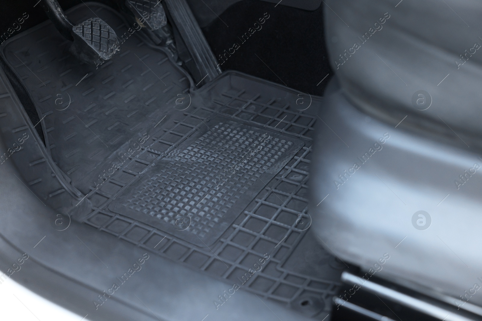 Photo of Black rubber car floor mat in auto