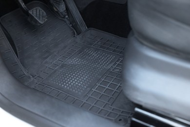 Photo of Black rubber car floor mat in auto