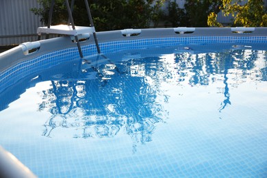 Above ground swimming pool outdoors on sunny day, closeup