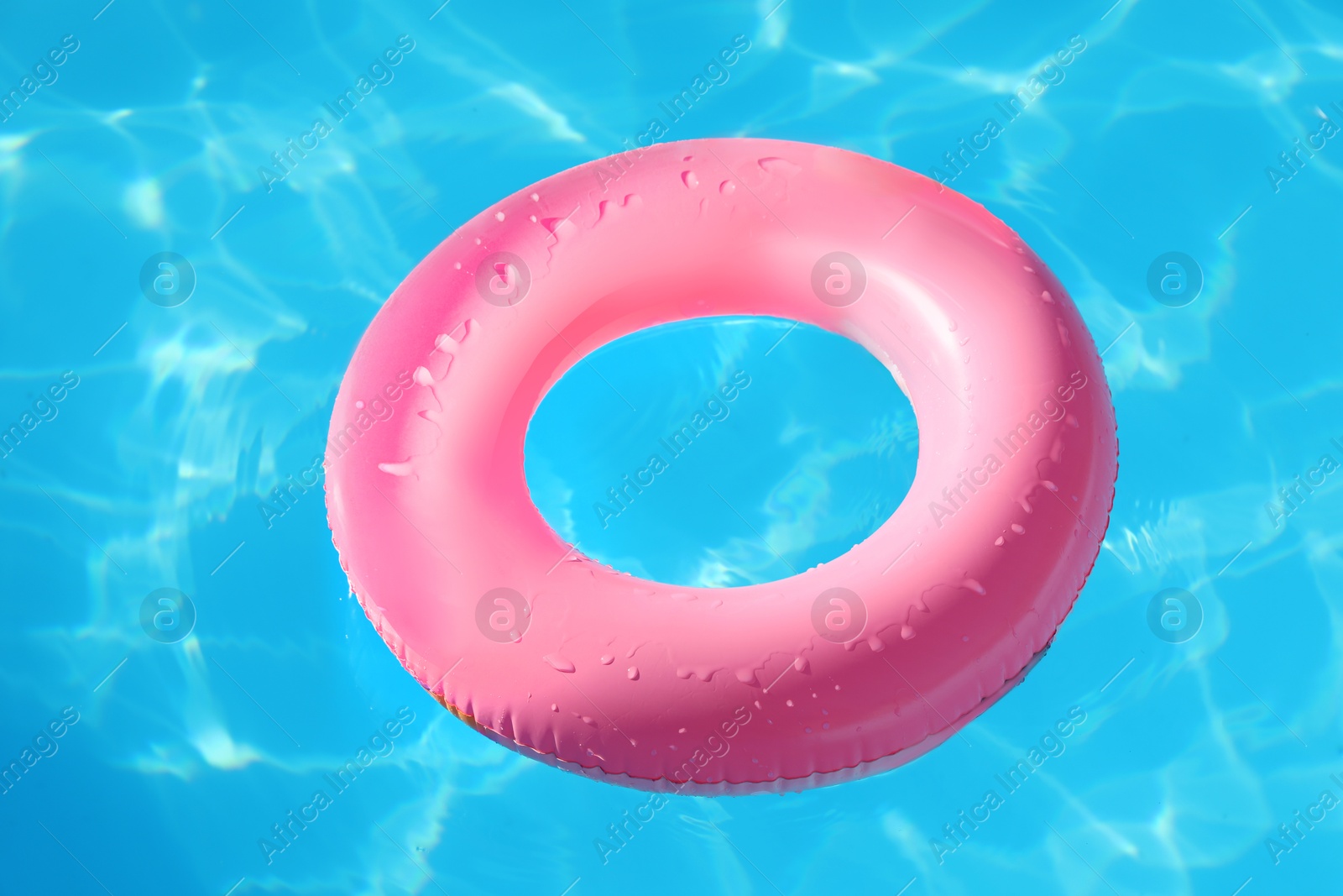 Photo of Pink inflatable ring in swimming pool outdoors