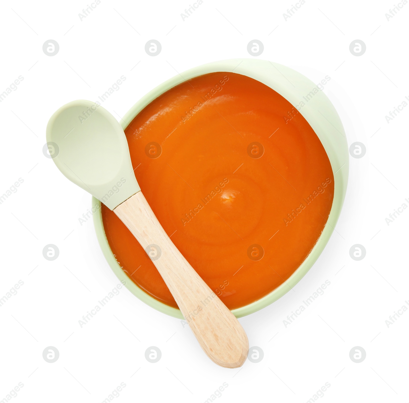 Photo of Tasty baby food in bowl and spoon isolated on white, top view