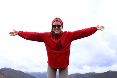 Happy young hiker in mountains. Active tourism