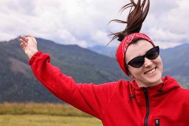 Photo of Happy young hiker in mountains. Active tourism