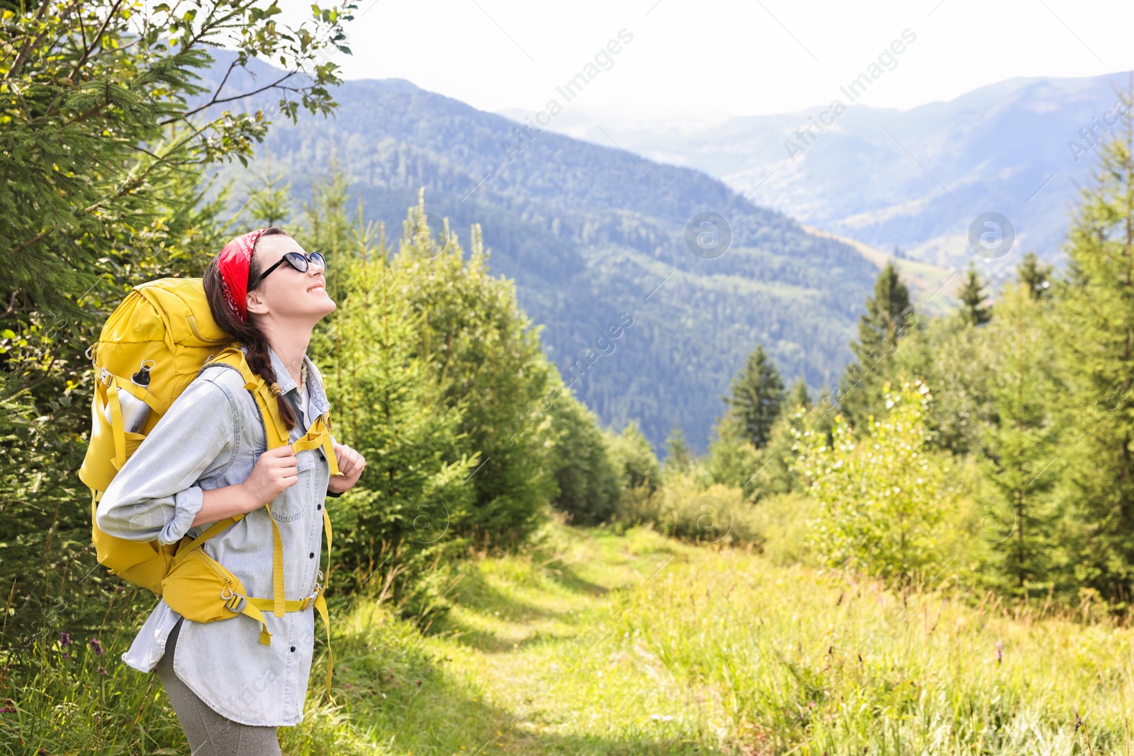 Photo of Young hiker with backpack enjoying time in forest