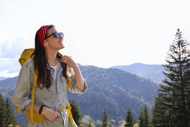 Photo of Young hiker with backpack in mountains on sunny day