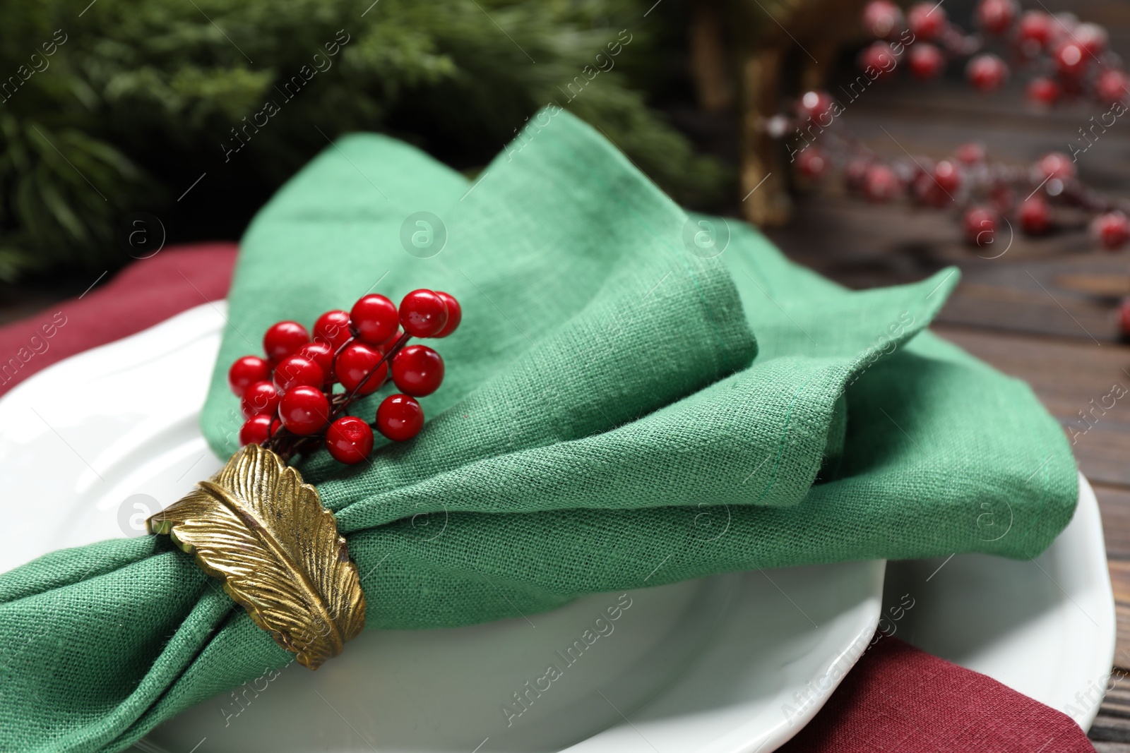 Photo of Christmas place setting with festive decor on table, closeup