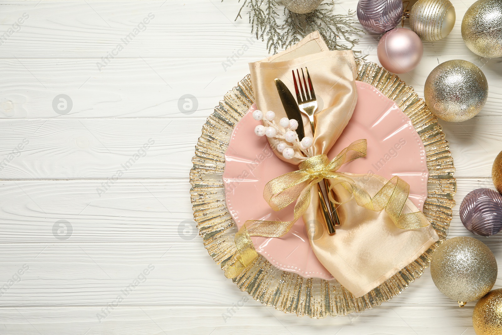 Photo of Christmas place setting with festive decor on white wooden table, flat lay. Space for text