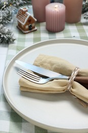 Photo of Christmas place setting with festive decor on white table, closeup