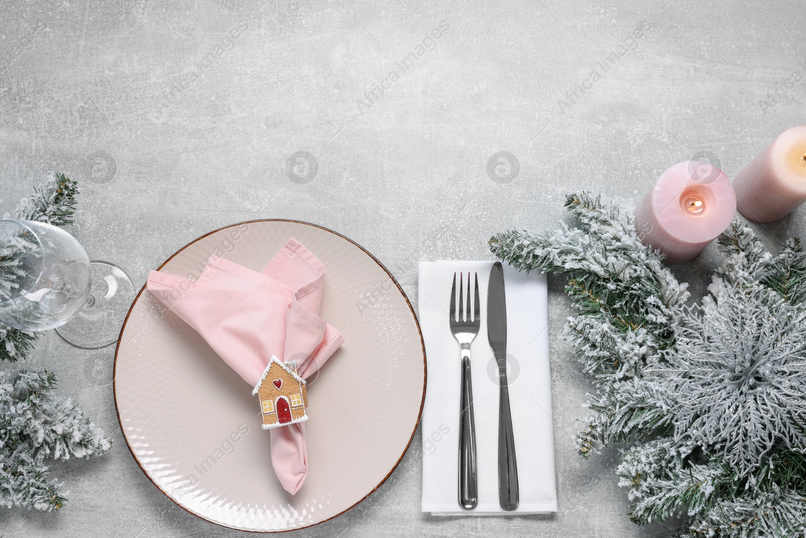 Photo of Christmas place setting with festive decor on grey textured table, flat lay. Space for text