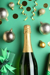 Photo of Flat lay composition with confetti and bottle of sparkling wine on green background. Christmas decor