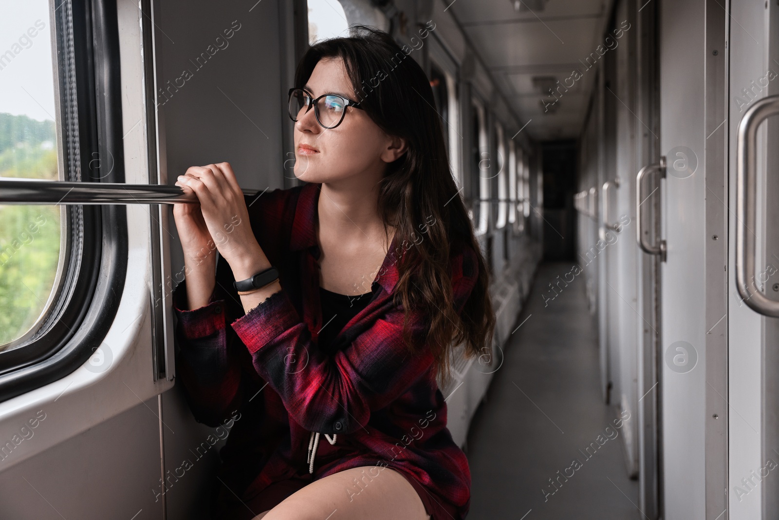 Photo of Beautiful woman looking out of train window during trip