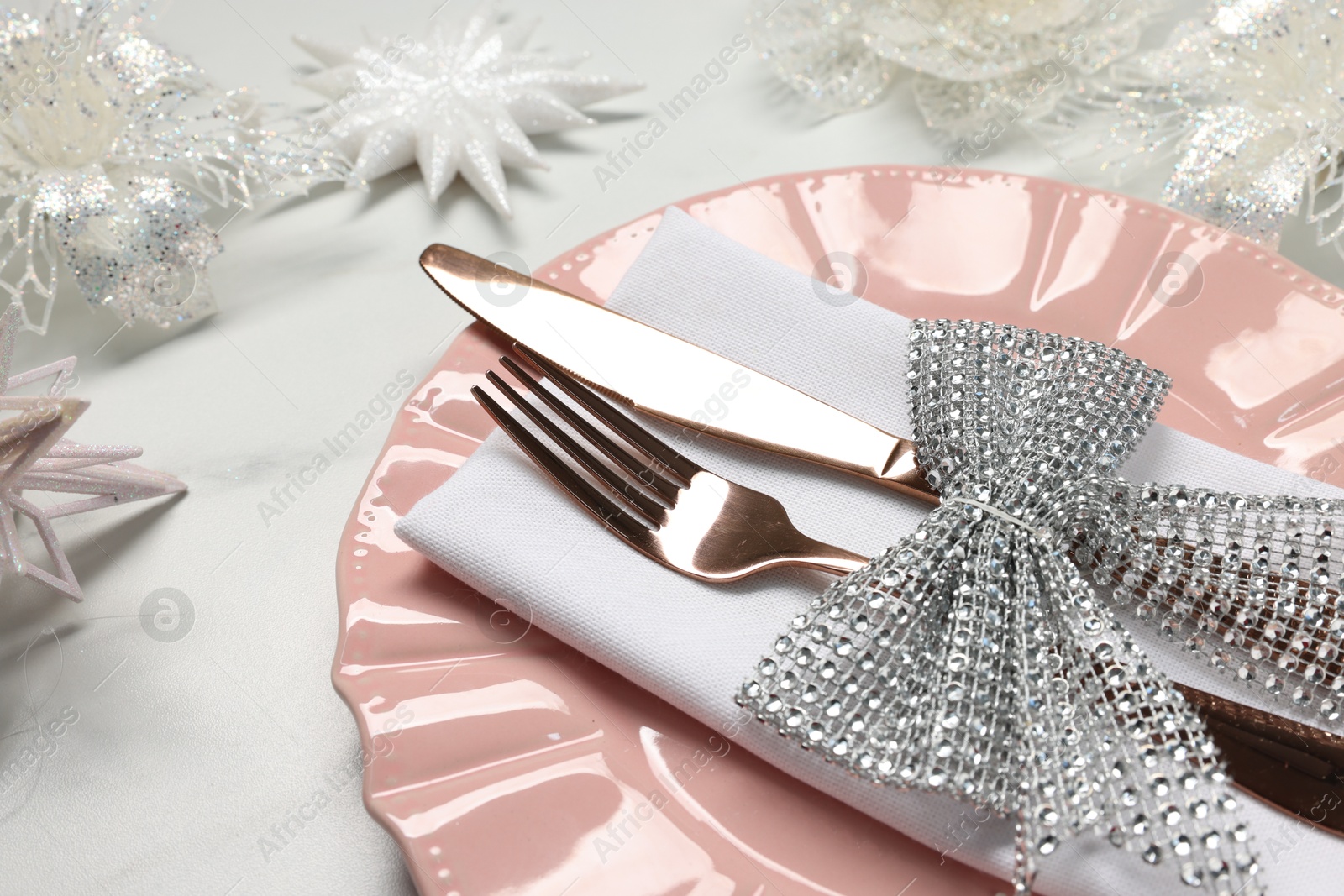 Photo of Christmas place setting with festive decor on white table, closeup