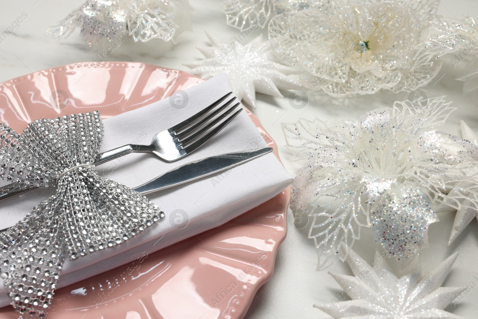 Photo of Christmas place setting with festive decor on white table, closeup