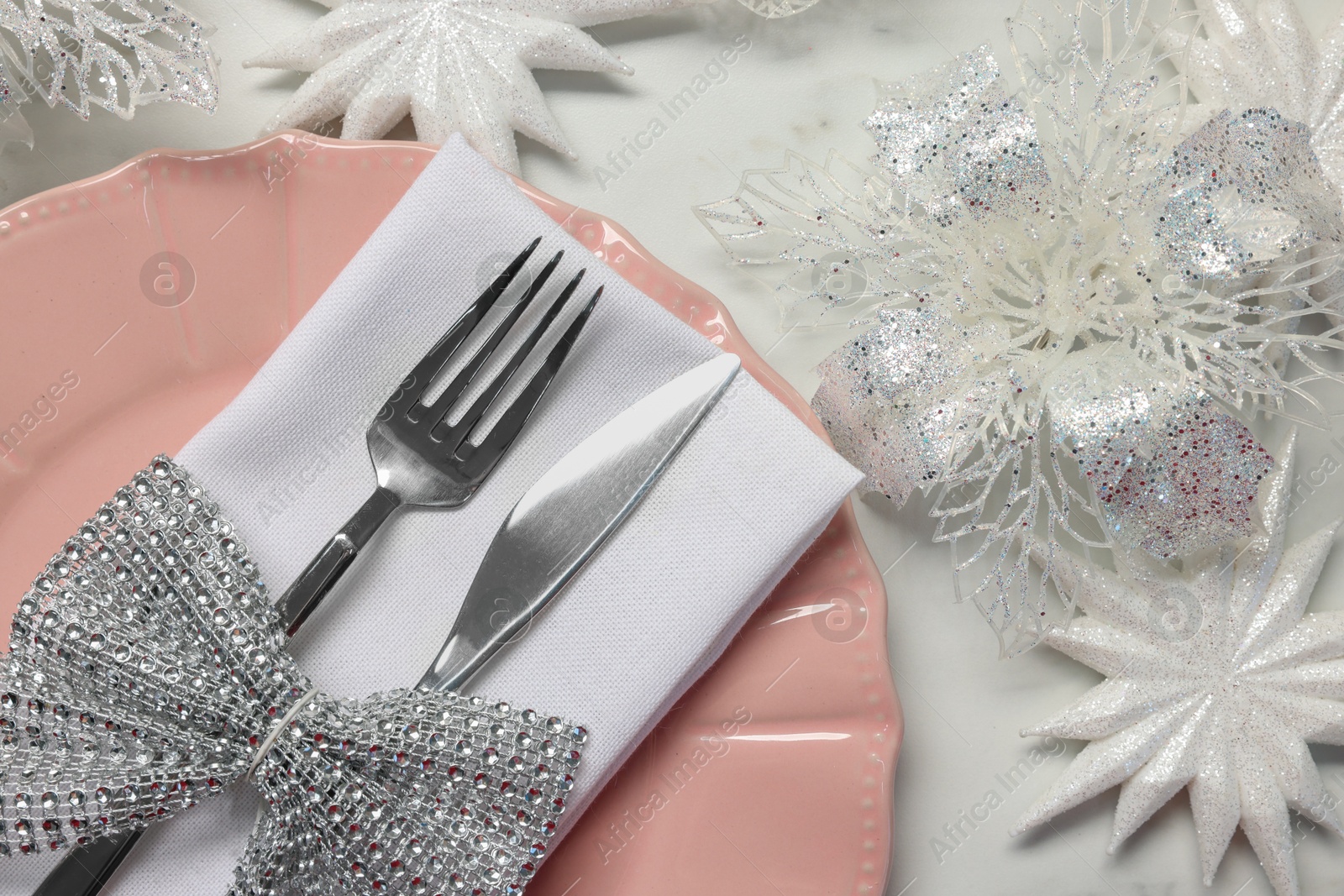 Photo of Christmas place setting with festive decor on white table, flat lay