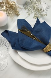 Photo of Christmas place setting with festive decor on white table, above view