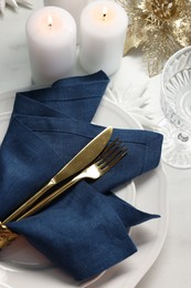 Photo of Christmas place setting with festive decor on white table, above view