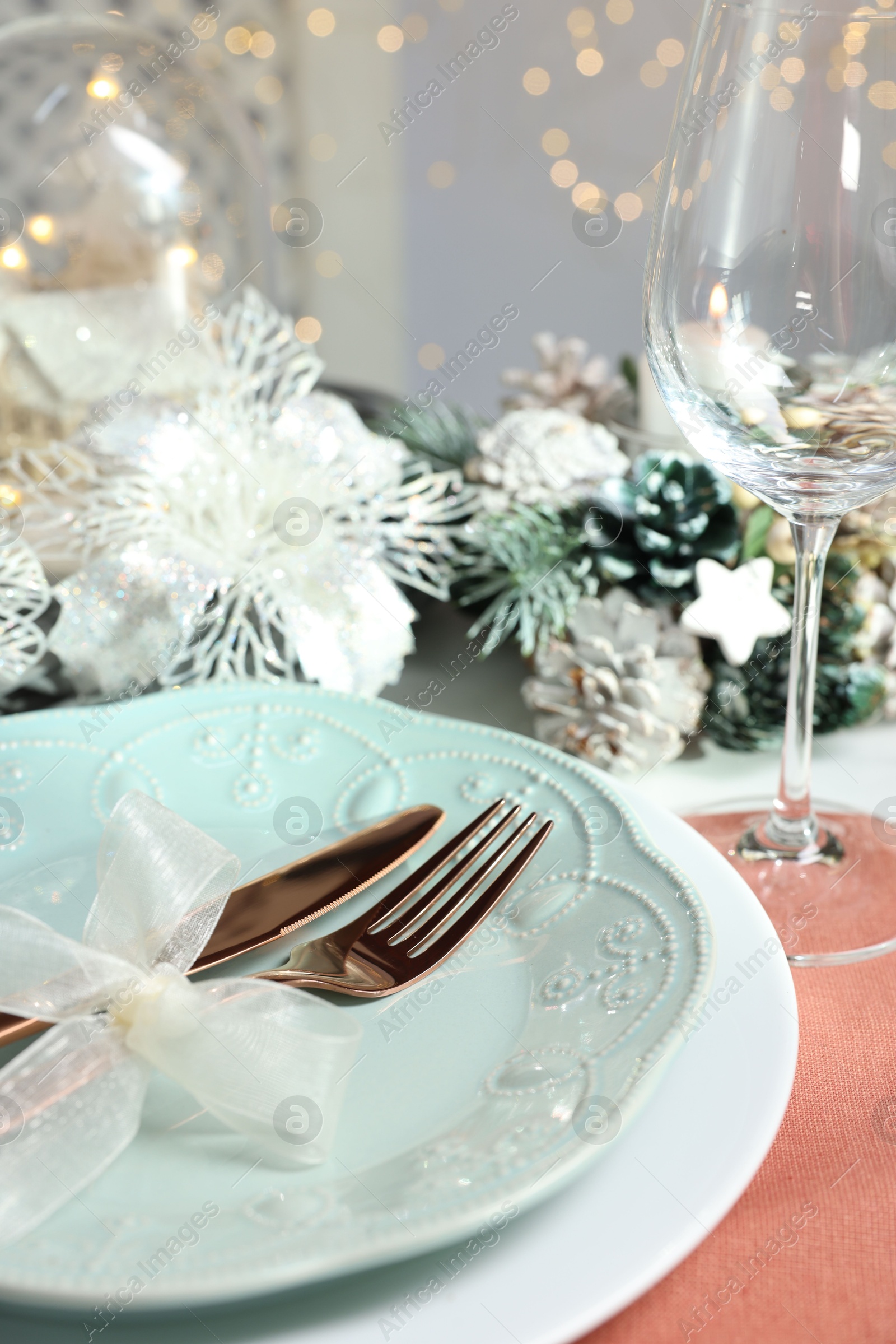 Photo of Christmas place setting with plates, cutlery and festive decor on table