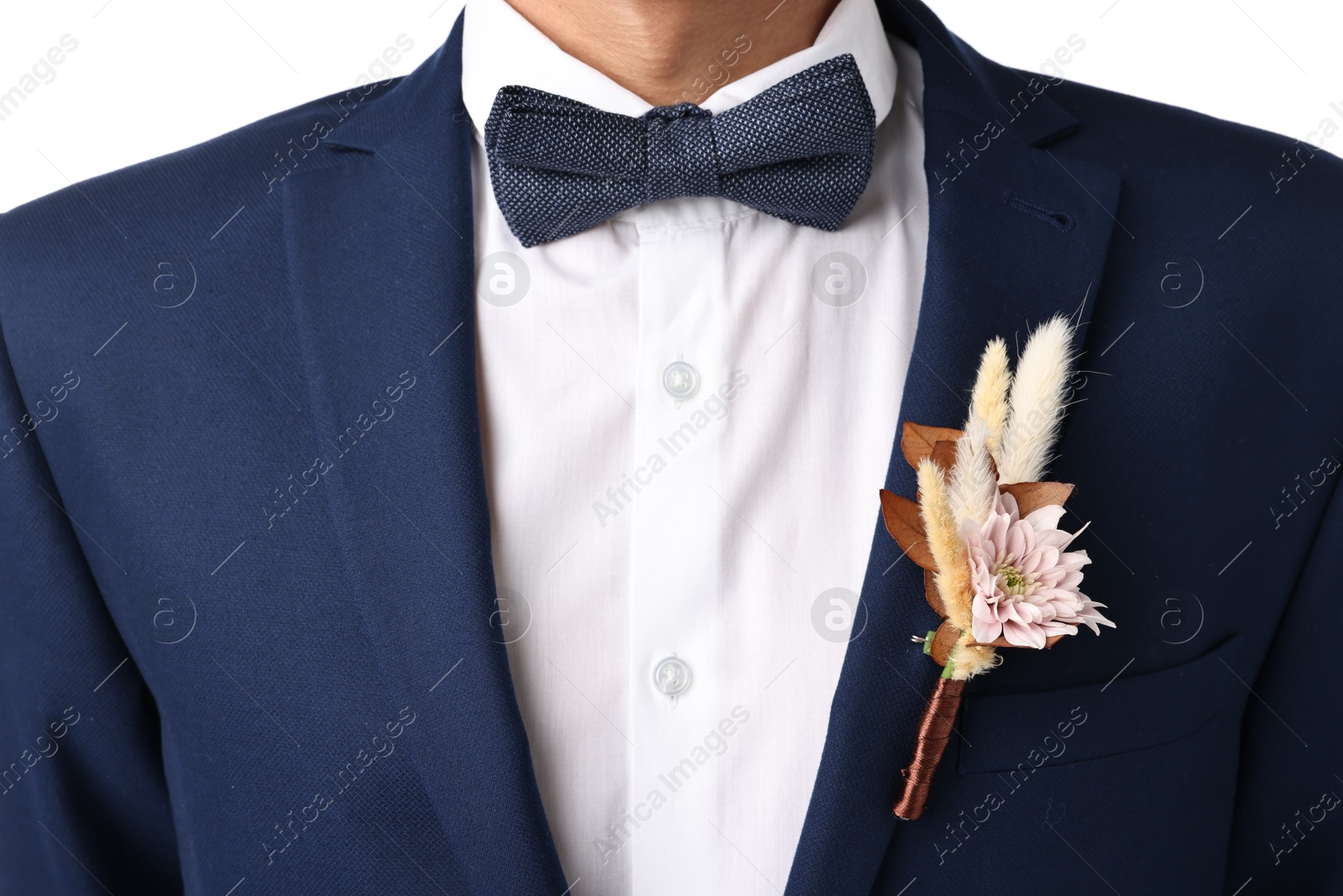 Photo of Groom in suit with stylish boutonniere on white background, closeup