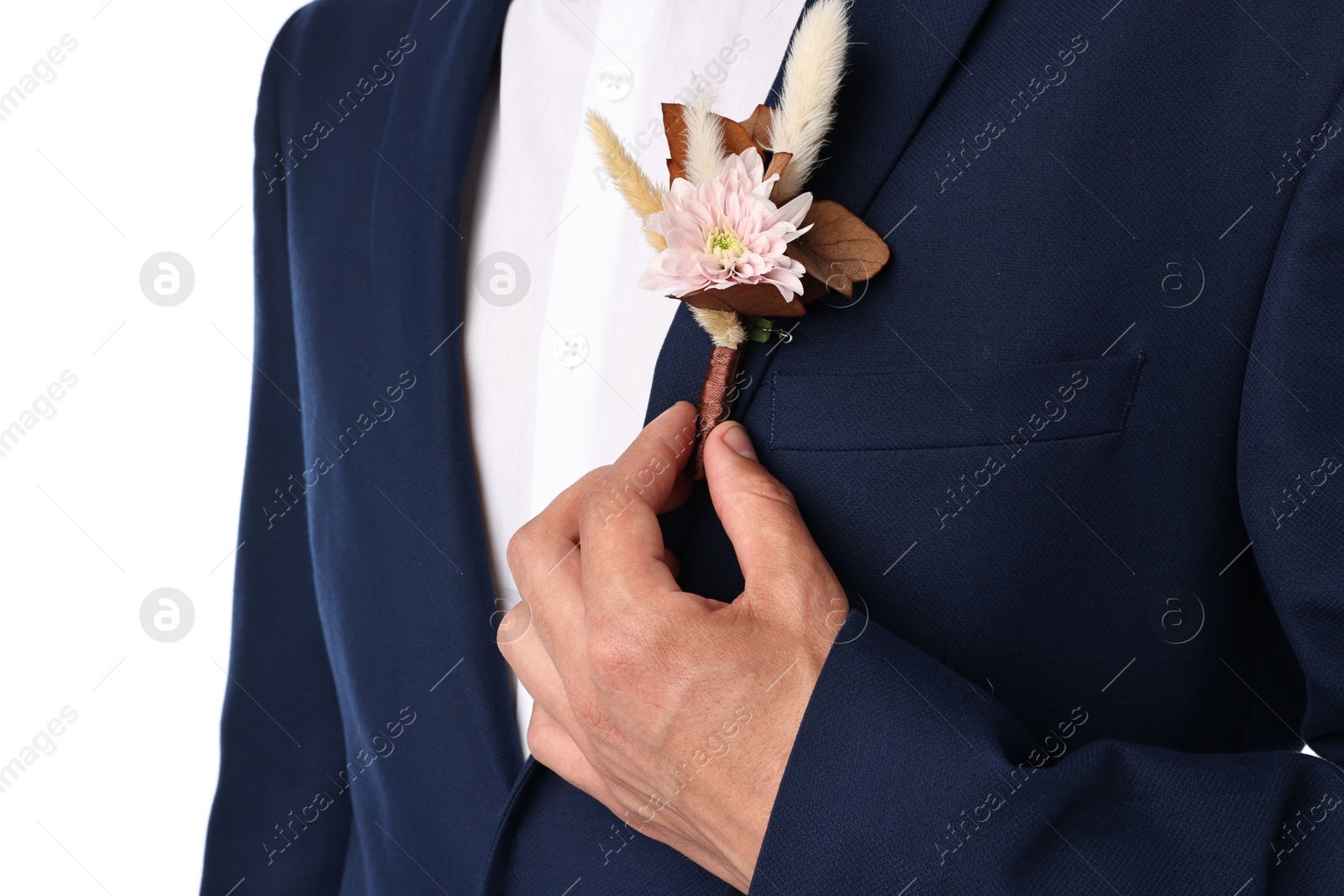 Photo of Groom in suit with stylish boutonniere on white background, closeup