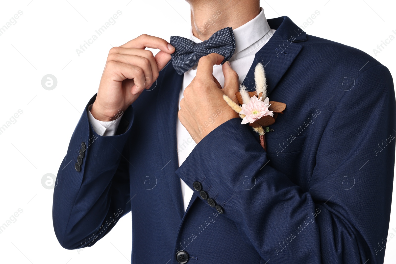 Photo of Groom in suit with stylish boutonniere on white background, closeup