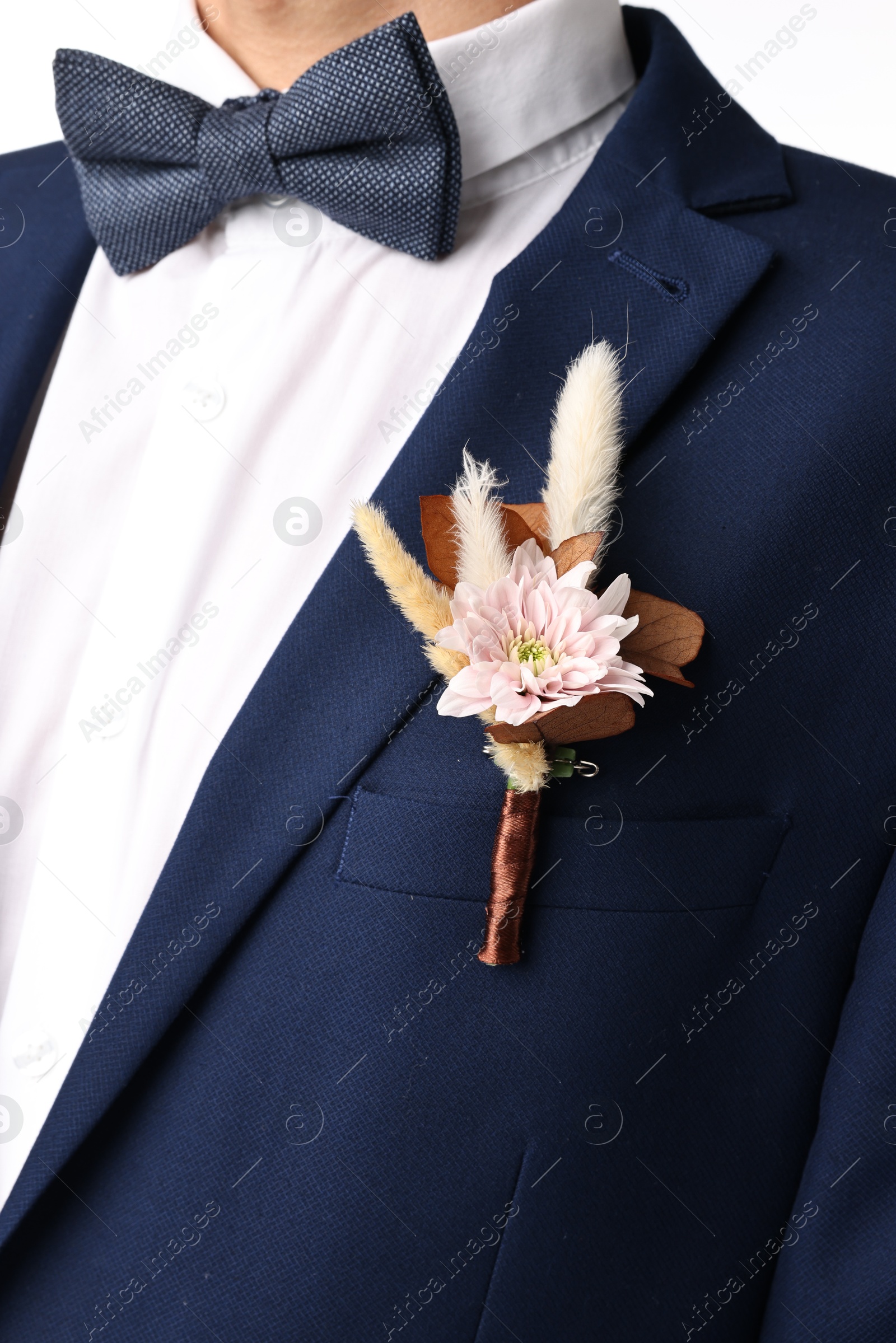 Photo of Groom in suit with stylish boutonniere on white background, closeup