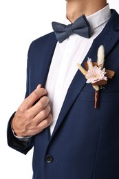 Photo of Groom in suit with stylish boutonniere on white background, closeup