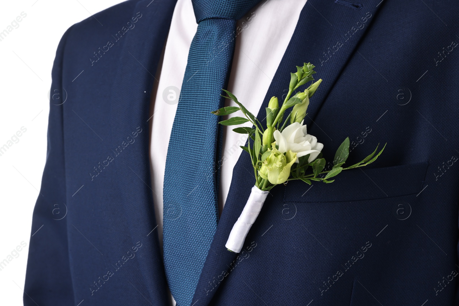 Photo of Groom in suit with stylish boutonniere on white background, closeup