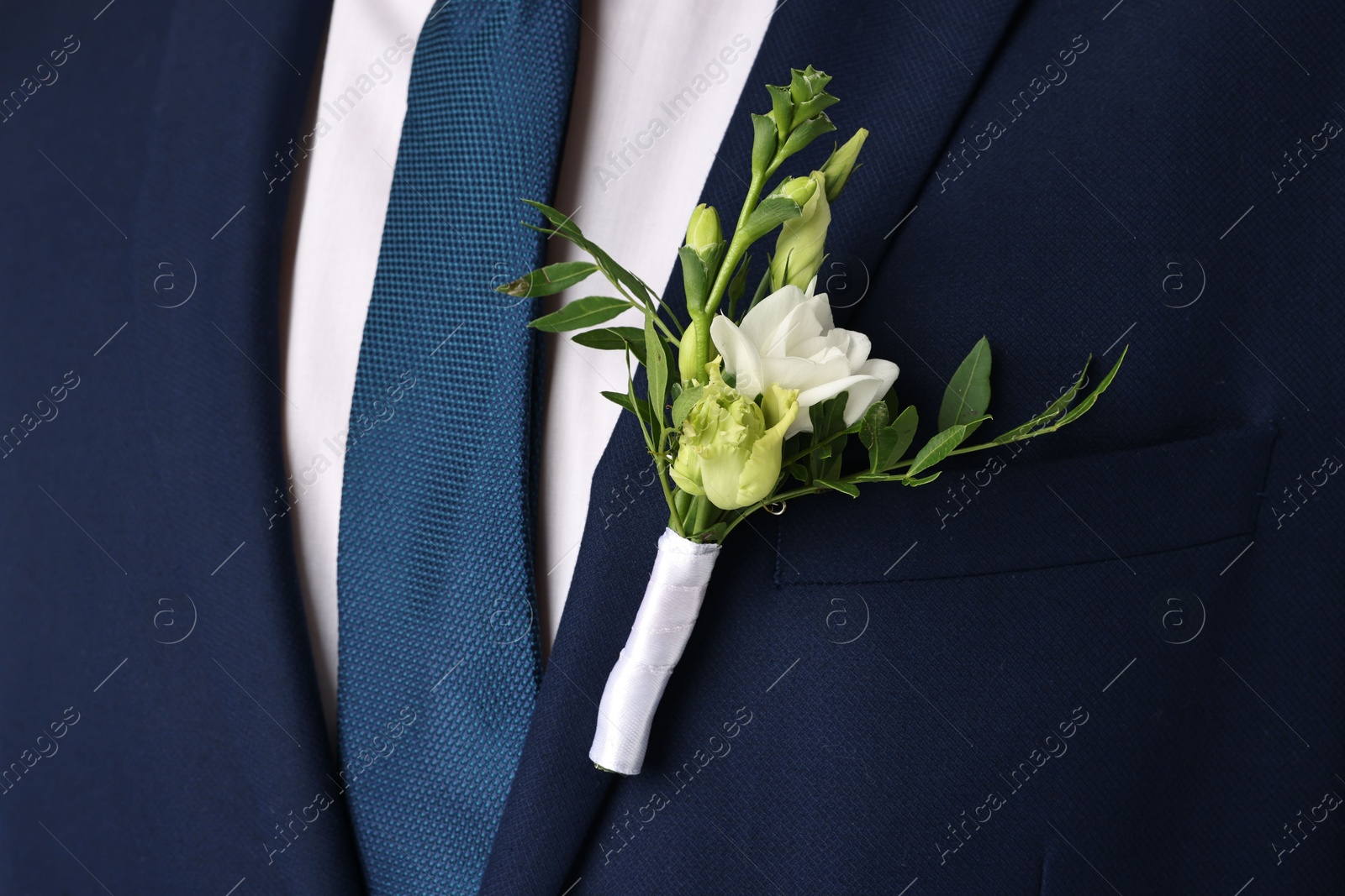 Photo of Groom in suit with stylish boutonniere, closeup