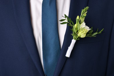 Photo of Groom in suit with stylish boutonniere, closeup