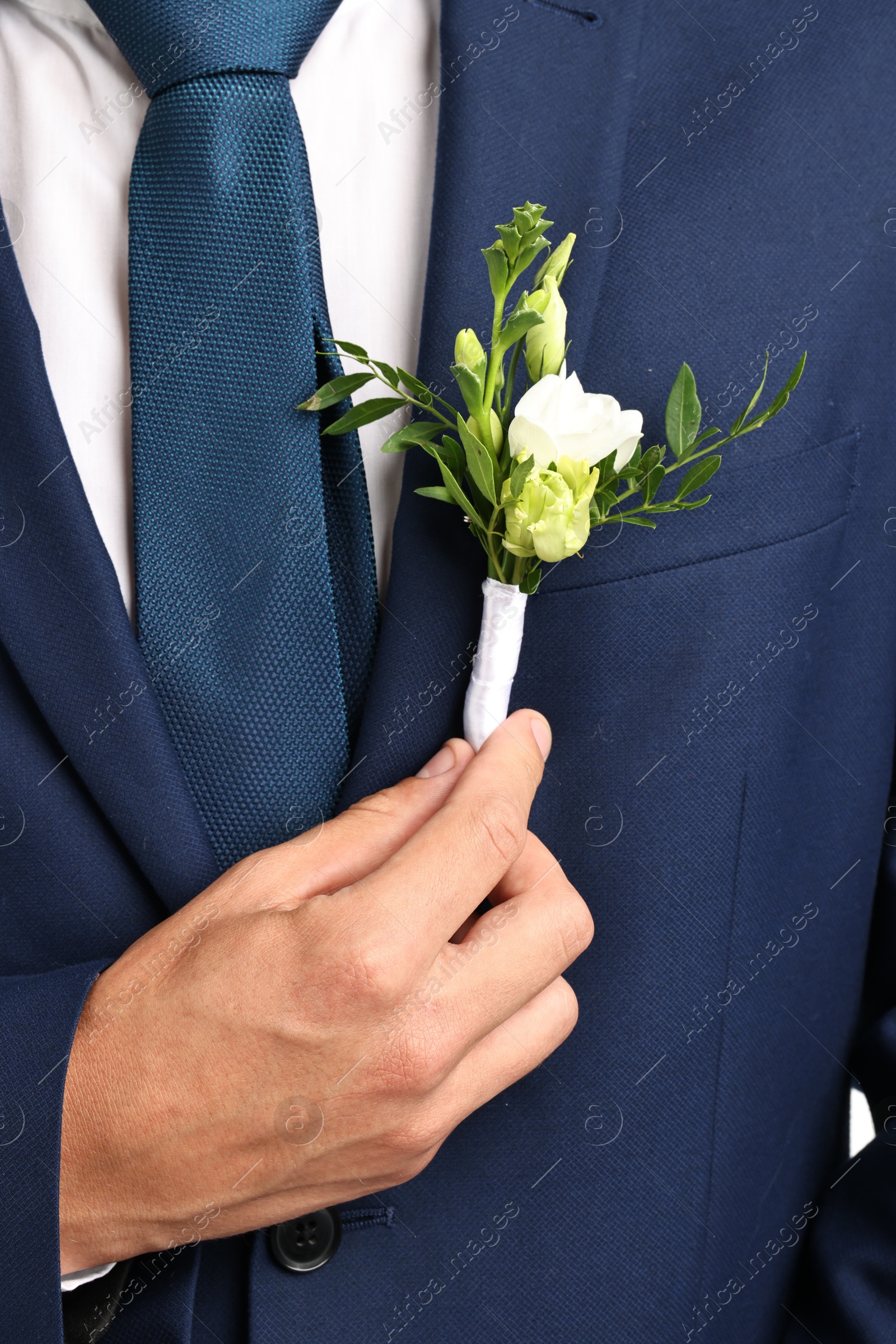 Photo of Groom in suit with stylish boutonniere, closeup