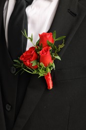 Photo of Groom in suit with stylish boutonniere, closeup