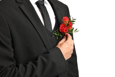 Photo of Groom in suit with stylish boutonniere on white background, closeup