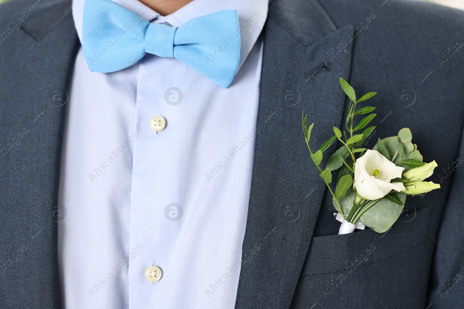 Photo of Groom in suit with stylish boutonniere, closeup