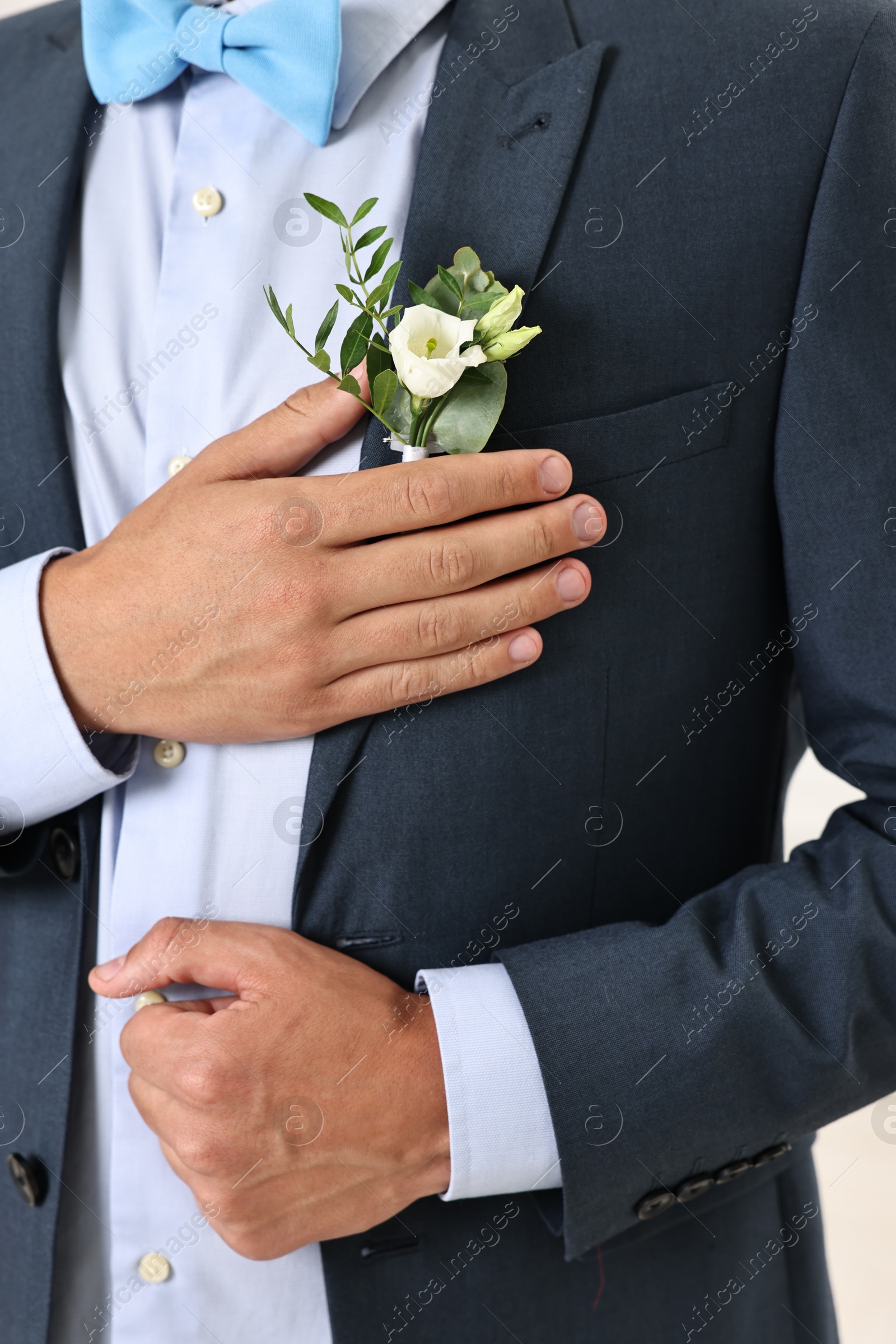 Photo of Groom in suit with stylish boutonniere, closeup