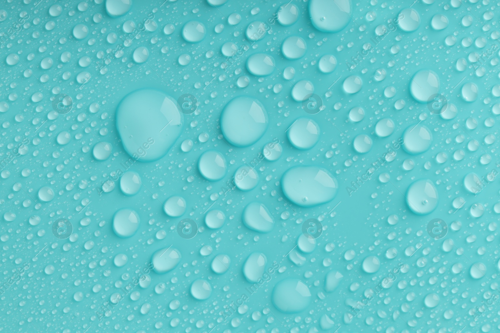 Photo of Water drops on turquoise background, top view