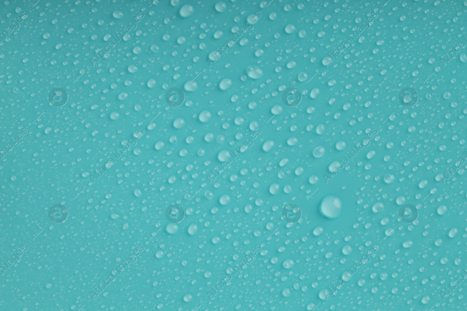 Photo of Water drops on turquoise background, top view