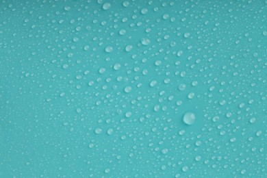 Photo of Water drops on turquoise background, top view