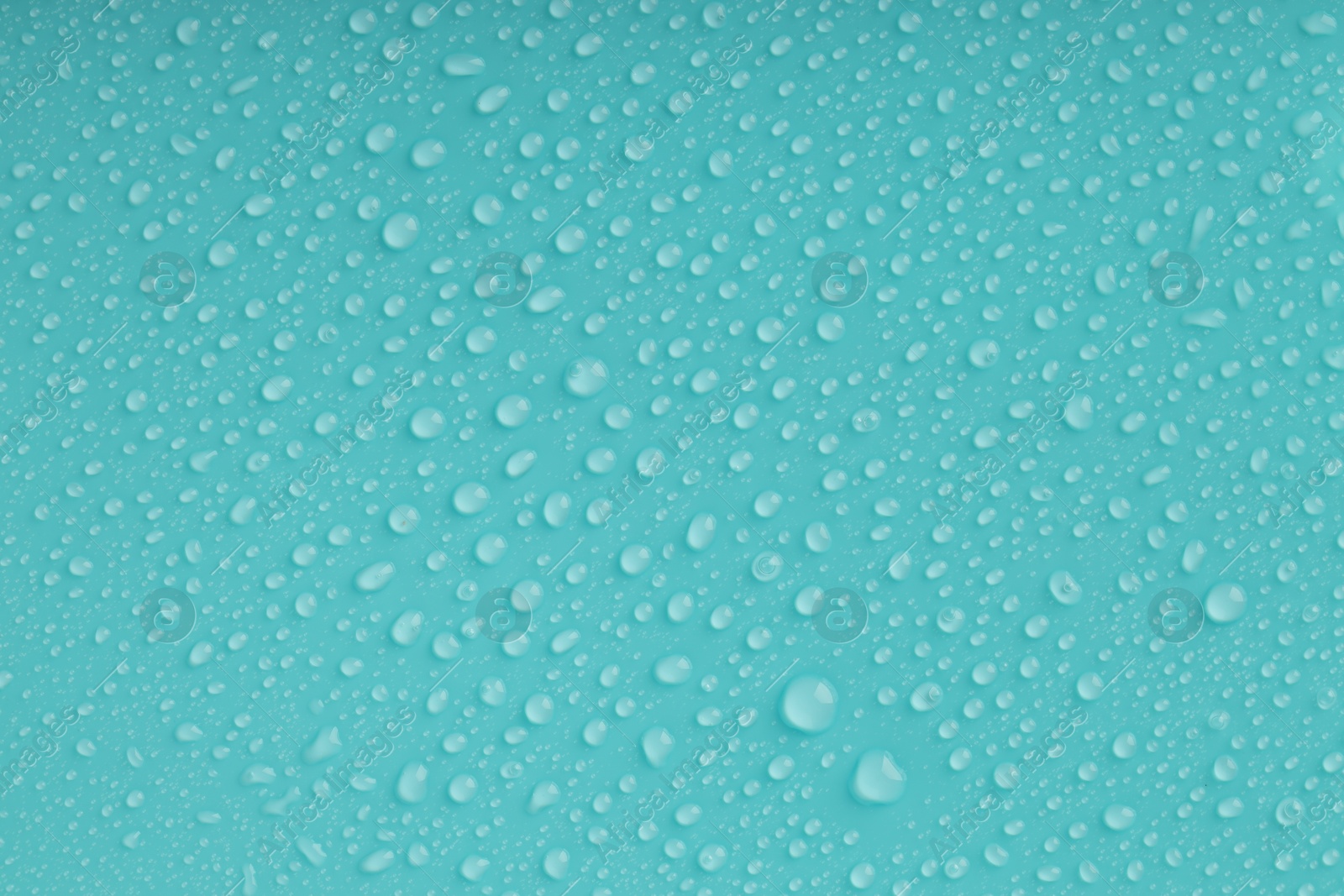 Photo of Water drops on turquoise background, top view