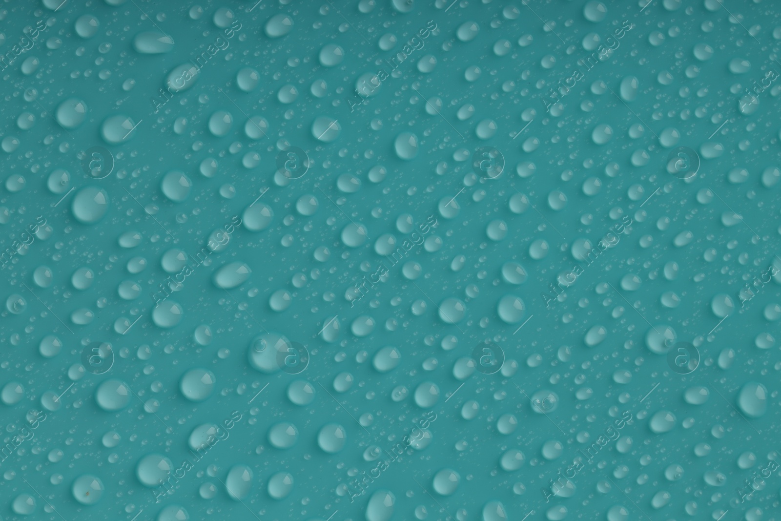 Photo of Water drops on turquoise background, top view