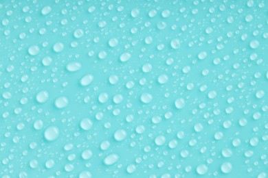 Photo of Water drops on turquoise background, top view