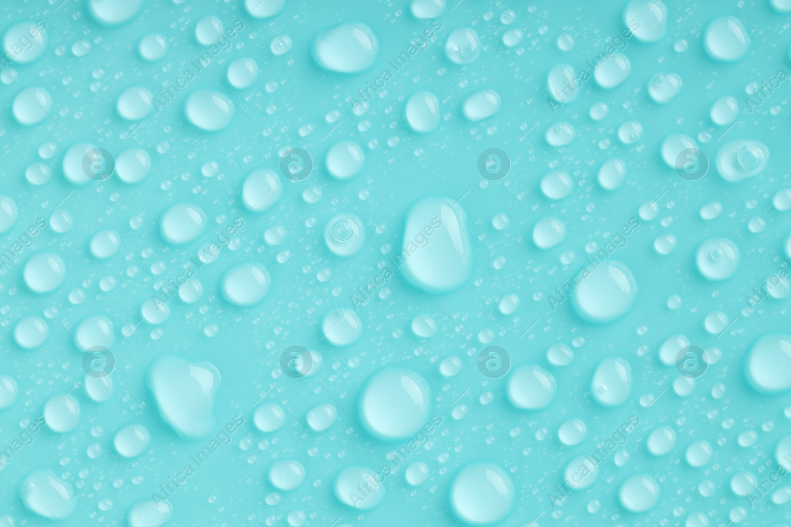 Photo of Water drops on turquoise background, top view