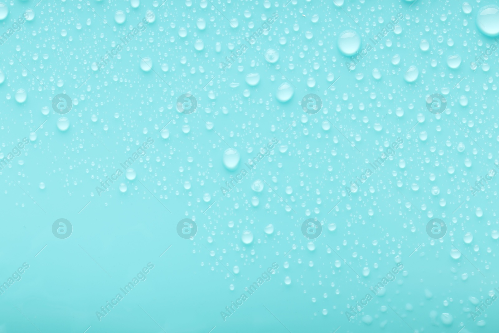 Photo of Water drops on turquoise background, top view