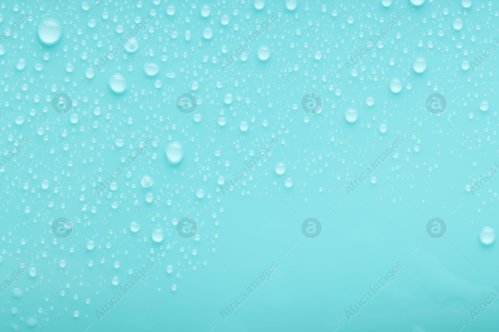 Photo of Water drops on turquoise background, top view