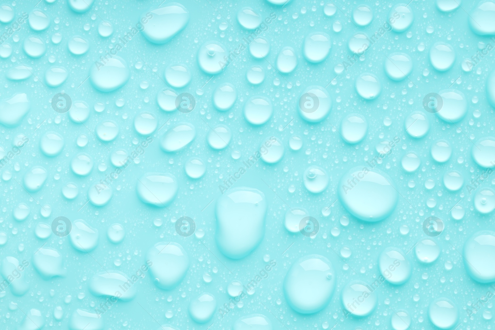 Photo of Water drops on turquoise background, top view