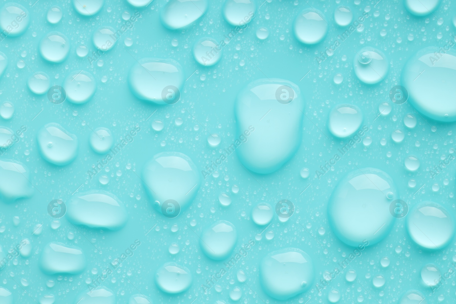 Photo of Water drops on turquoise background, top view