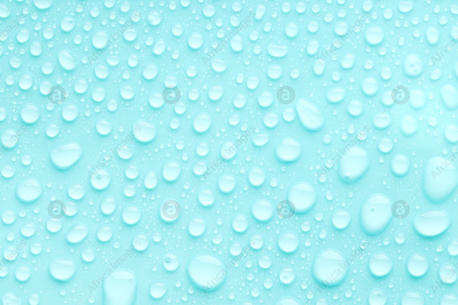 Photo of Water drops on turquoise background, top view