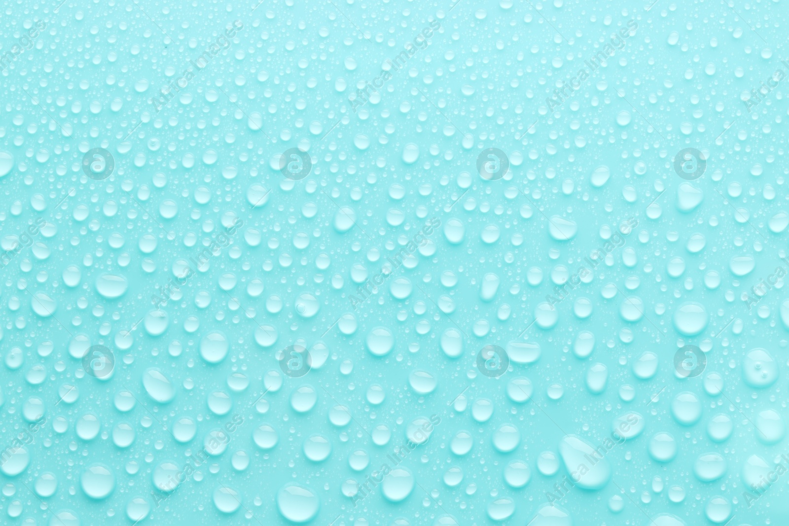 Photo of Water drops on turquoise background, top view