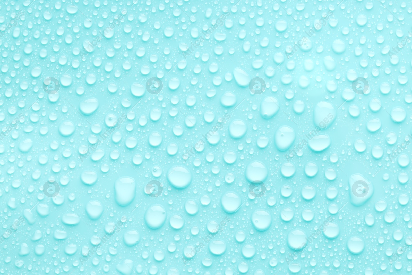 Photo of Water drops on turquoise background, top view