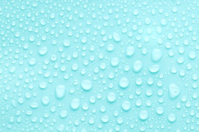 Photo of Water drops on turquoise background, top view