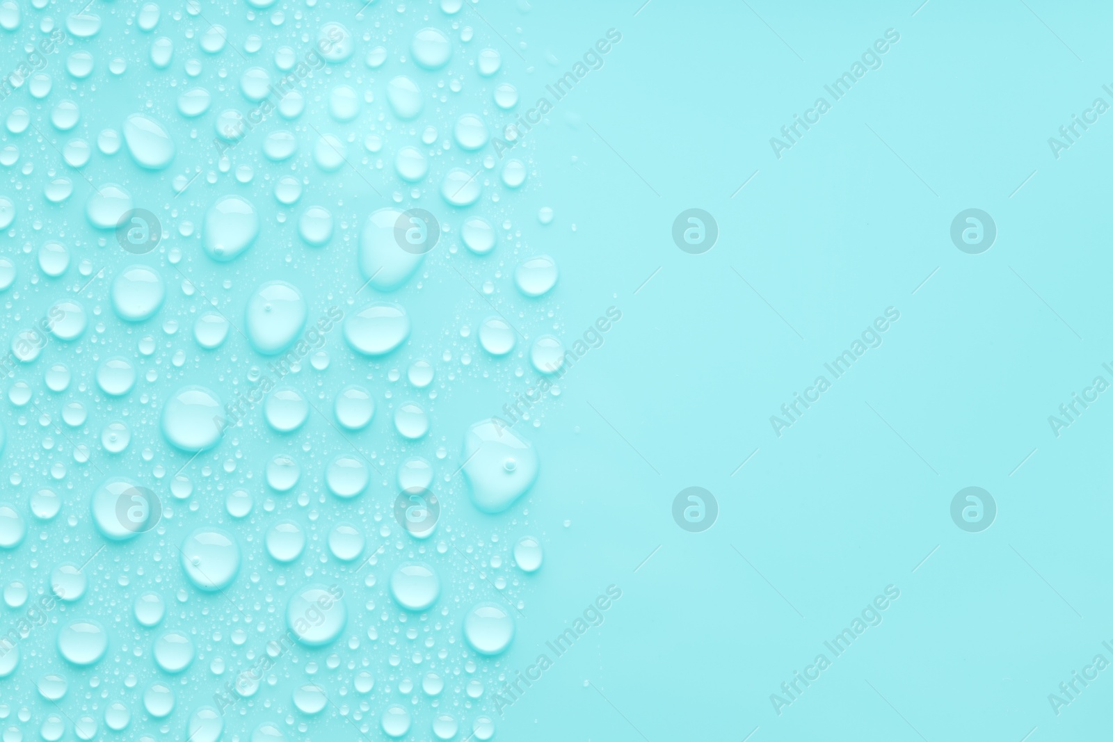 Photo of Water drops on turquoise background, top view. Space for text